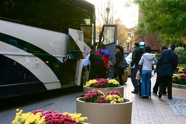 Local Motion Coach Bus picks up passengers in Boston. Local Motion Coach Bus picks up passengers in Boston.